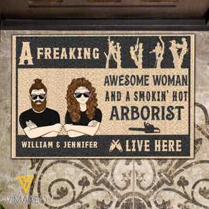 Personalized A Freaking Awesome Woman And A Smokin' Hot Arborist Live Here Christmas Doormat Printed NOV-MQ12